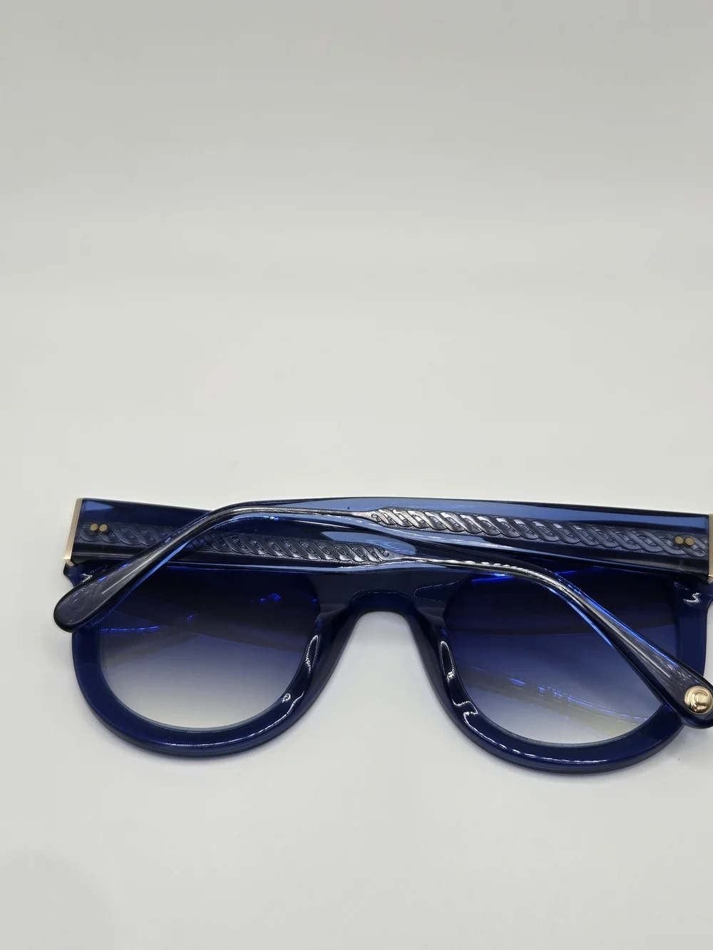Aperçu sunglasses featuring a bold acetate frame and gold tone branding